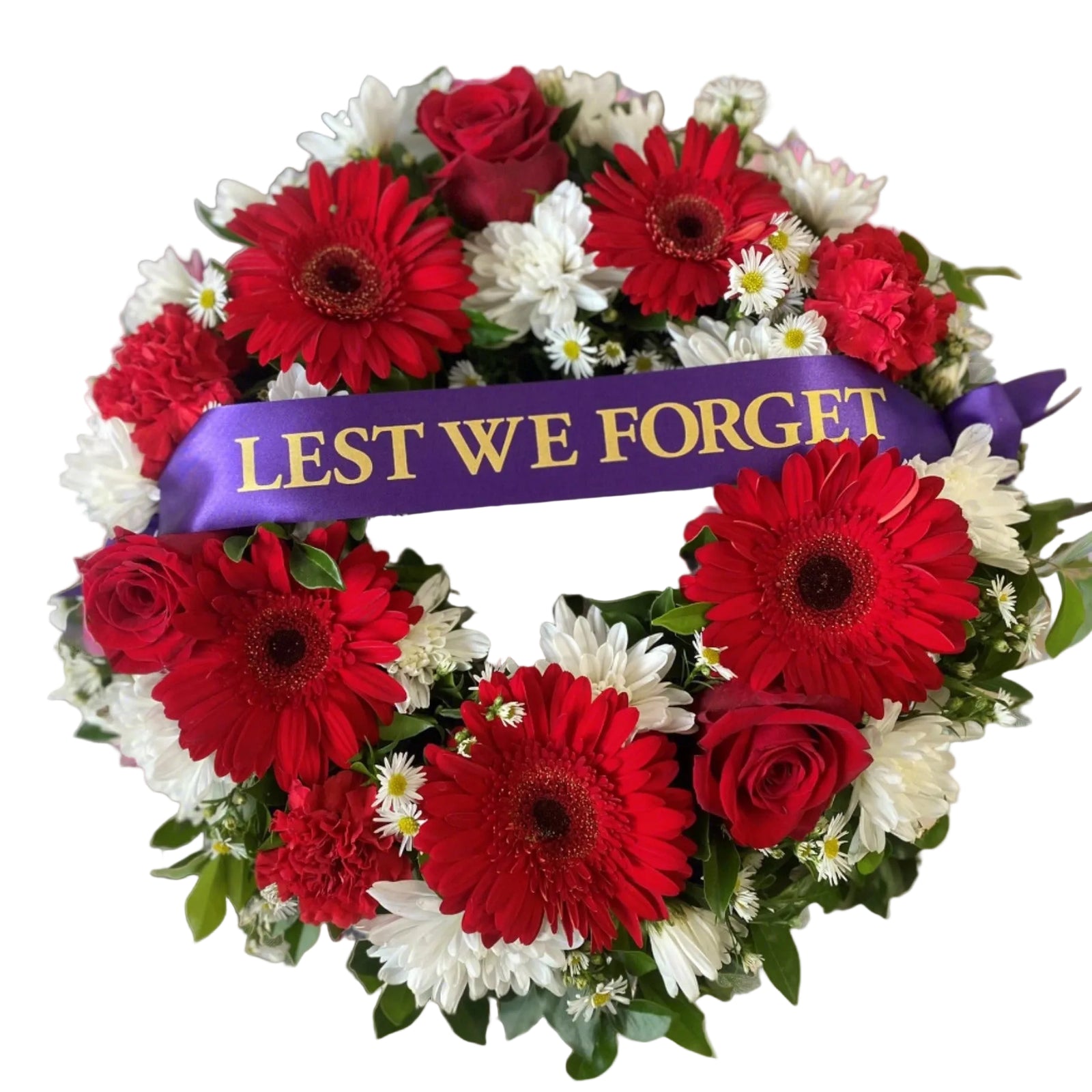 A floral wreath with predominantly red and white flowers, featuring a purple satin ribbon with the inscription 'LEST WE FORGET' in yellow letters.